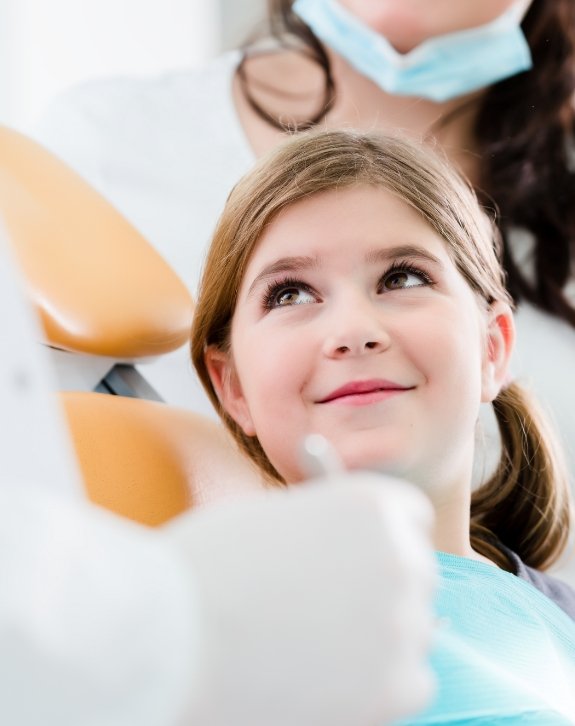 Child smiling during children's dentistry visit