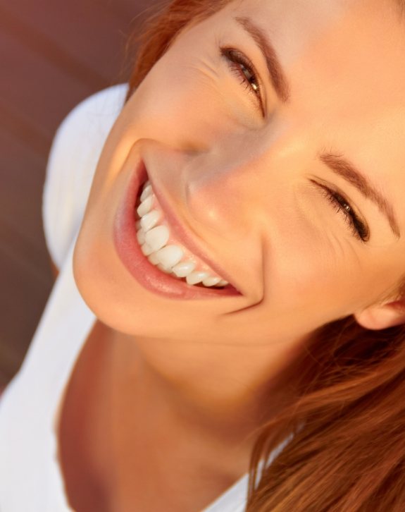 Woman with flawless smile after cosmetic dentistry