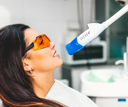Woman receiving professional teeth whitening