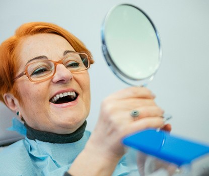 A woman enjoying the benefits of dentures in Clarendon Hills