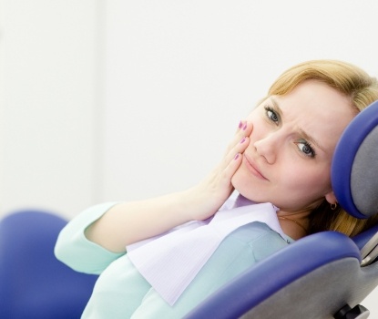 Woman in pain before treatment from her emergency dentist