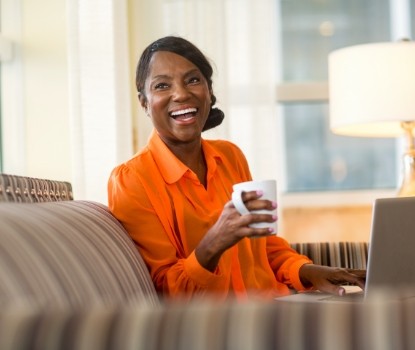 Smiling woman enjoying the benefits of dental implants