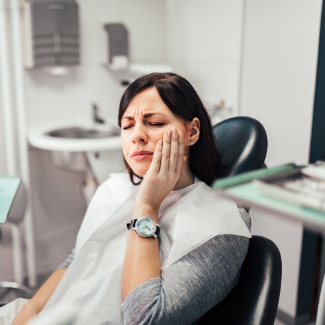 Woman in pain before emergency dentistry treatment