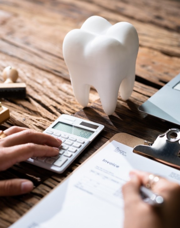 Dentist calculating dental insurance