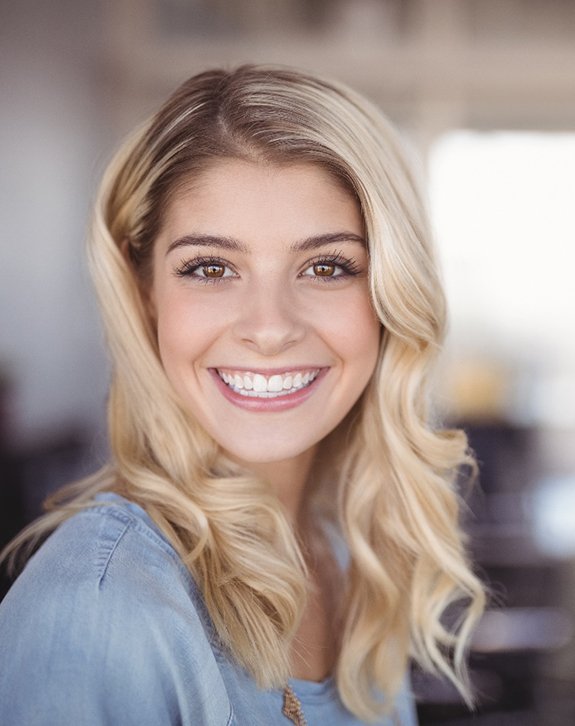 closeup of young woman smiling inside home