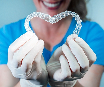 dental professional holding two clear aligners 
