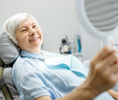 Woman with dentures looking at smile