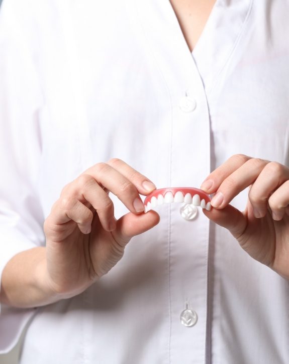 Dentist holding a dental restoration