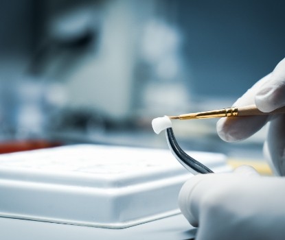 Dental lab technician crafting a dental crown