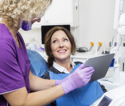 Dentist and dental patient looking at pictures captured by intraoral camera
