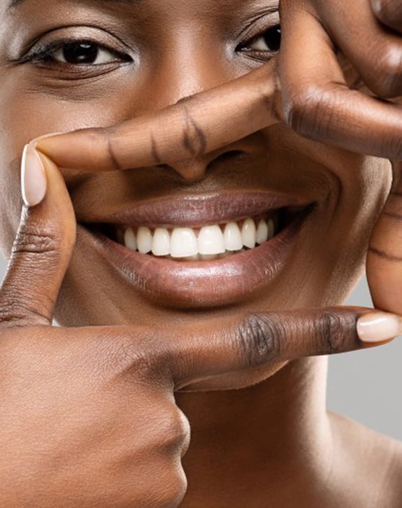 Woman outlining her smile with her fingers