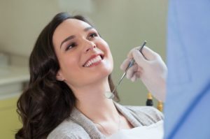 Smiling female patient at dentist